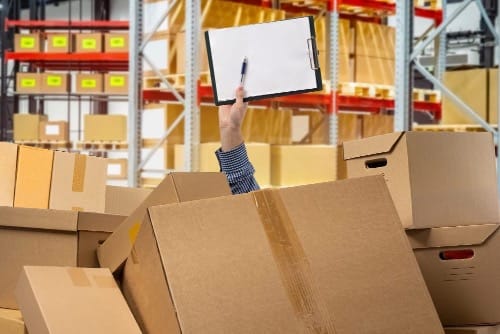 A picture of a room full of unorganized boxes